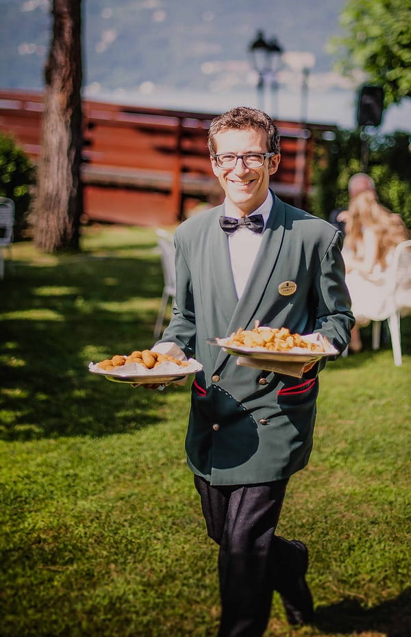 Man carrying plates of wedding food