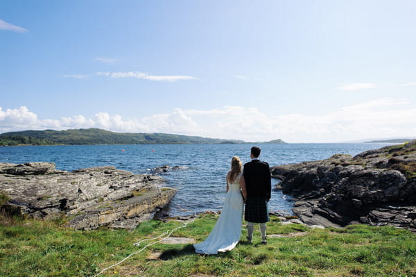 Bride and groom looking out over Loch Melfort