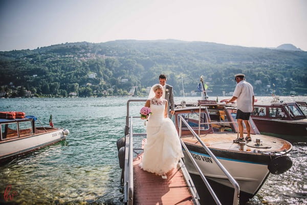 Bride and groom getting off boat