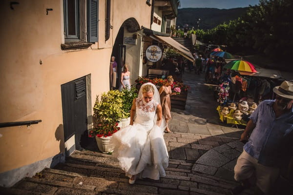 Bride walking up steps in Italy