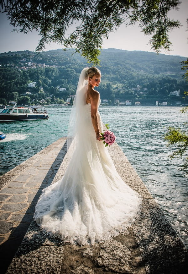 Bride holding bouquet by Lake Maggiore, Italy