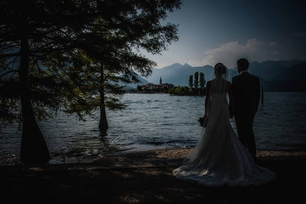 Bride and groom looking over Lake Maggiore, Italy