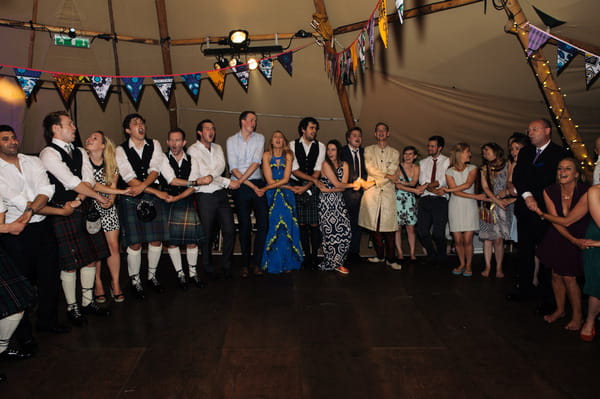 Wedding guests in circle on dance floor