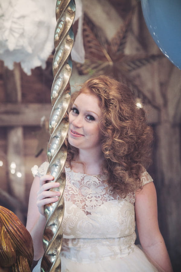 Bride holding onto carousel pole