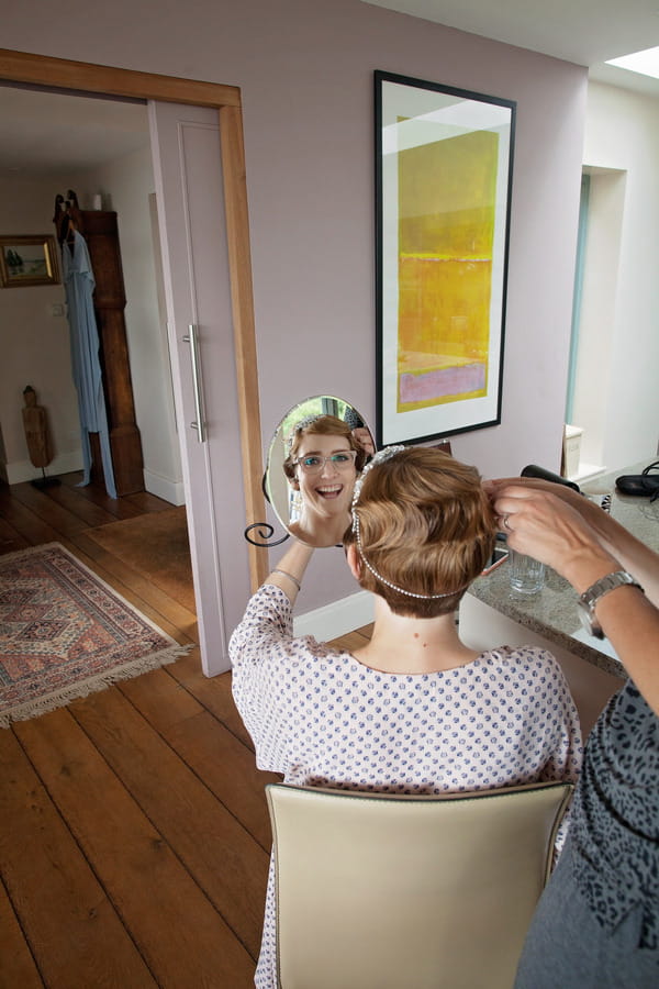 Reflection of bride's face in mirror