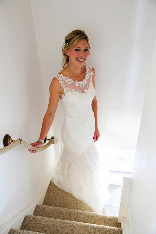 Bride standing on stairs in Elizabeth Van Stone wedding dress