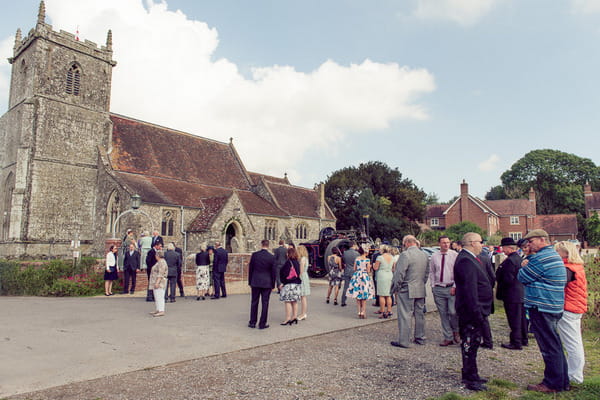Wedding guests outside Stourpaine Holy Trinity Church in Dorset