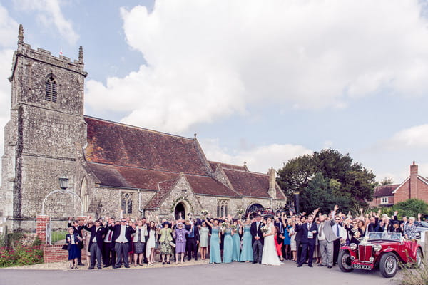 Wedding group shot outside Stourpaine Holy Trinity Church in Dorset