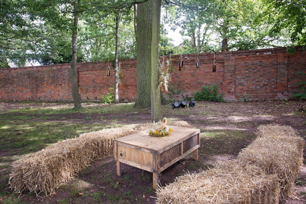 Rustic table and hay bales at wedding