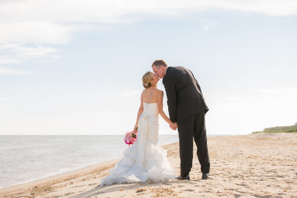 Bride and groom kiss on Nantucket Island beach
