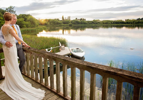 Bride on balcony overlooking lake