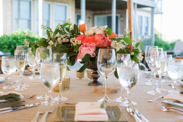 Wedding place setting with bright flowers