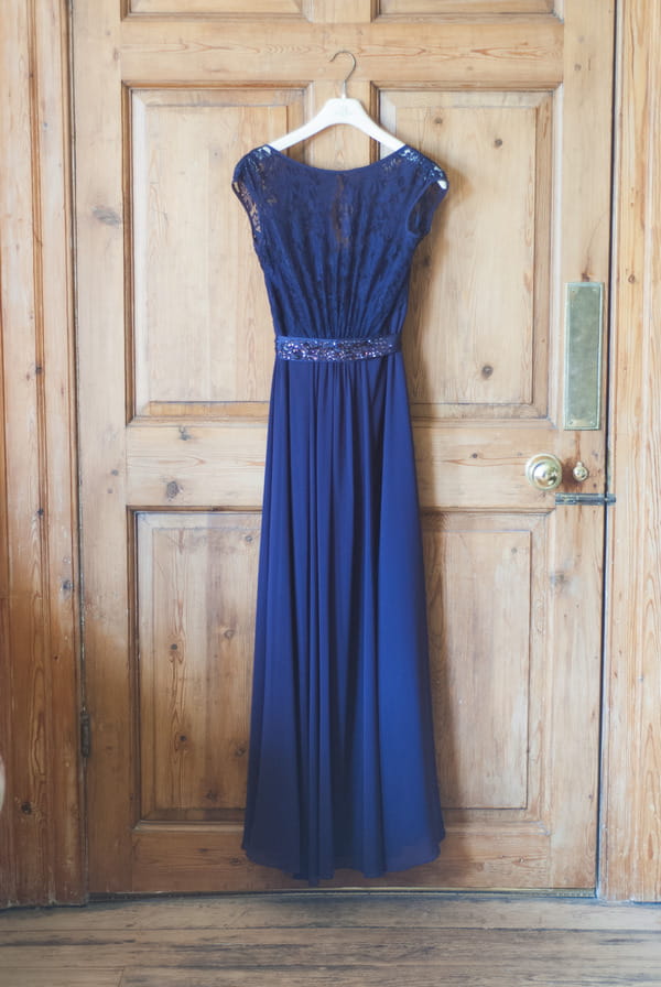 Purple bridesmaid dress hanging on door