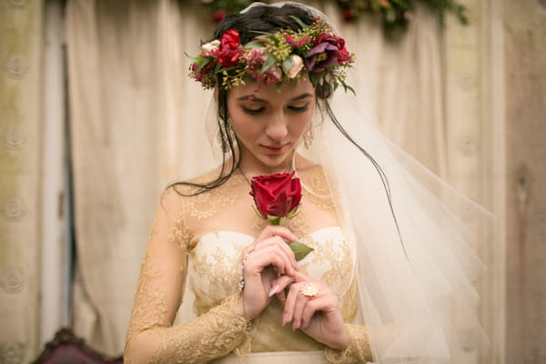 Bride with flower crown holding rose