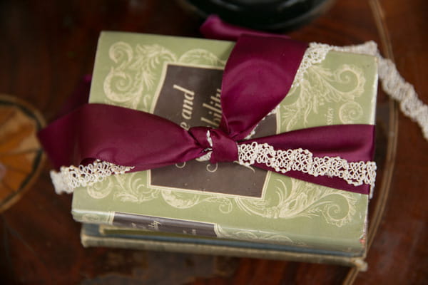 Books with marsala coloured ribbon