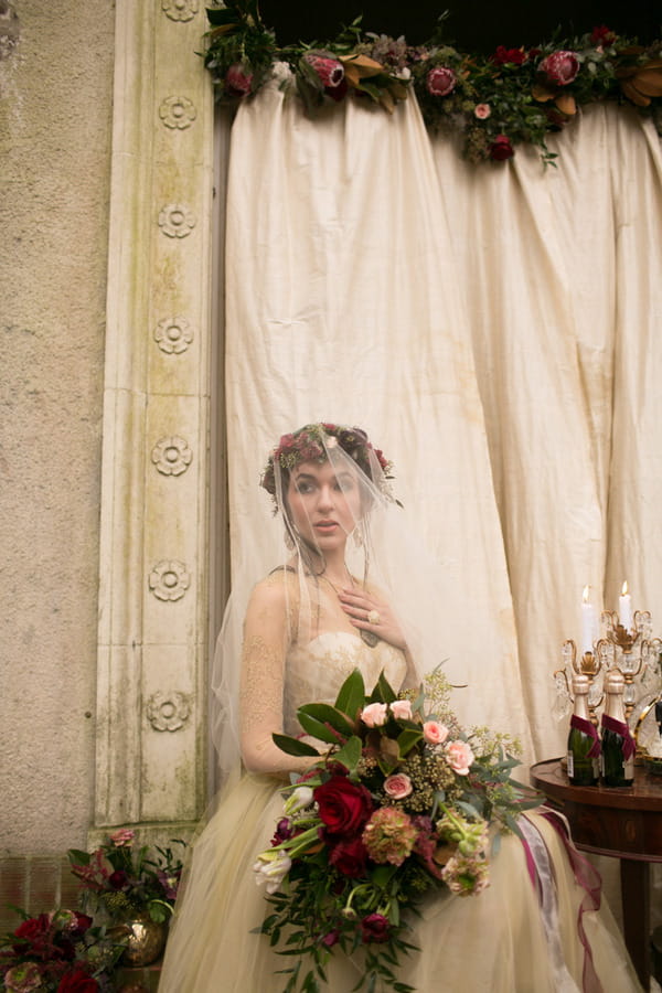 Bride with veil holding large bouquet