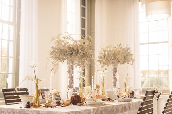 Long wedding table with tall flower centrepieces