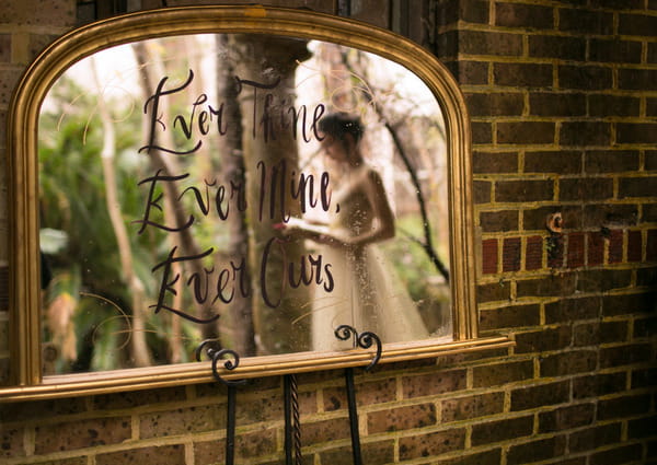 Reflection in mirror of bride reading Beethoven inspired love letter