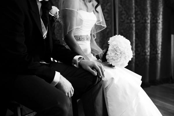 Bride with hand on groom's knee