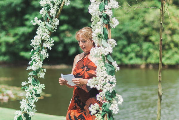 Wedding reading by lake at Narborough Hall Gardens