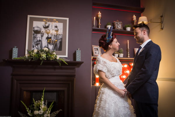 Bride and groom by fireplace at The Alverton Hotel