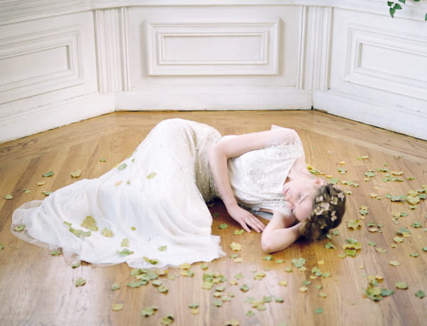 Bride laying on floor with leaves