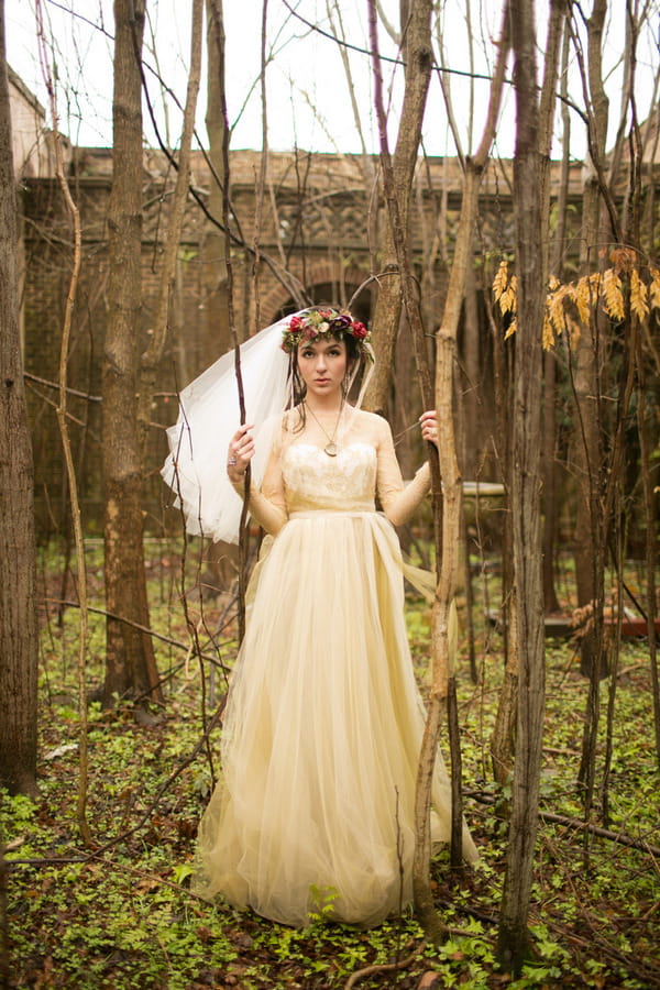 Bride standing in woodland