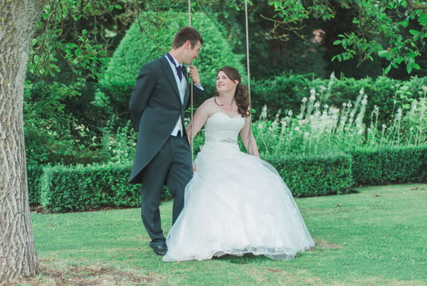 Bride and groom on swing at Narborough Hall Gardens