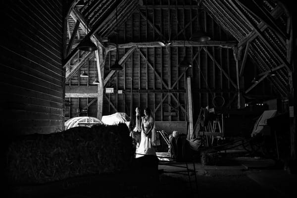 Bride and groom in barn at Layer Marney Tower