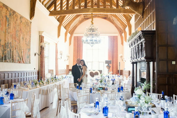 Bride and groom in wedding breakfast room at Layer Marney Tower