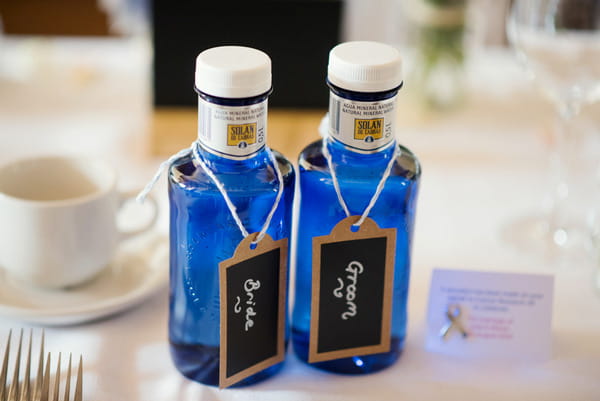 Blue glass bottles on wedding table