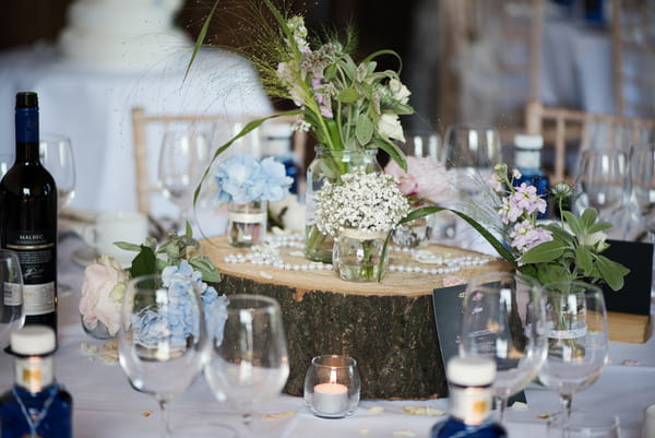 Log slice and flowers for wedding table centrepiece