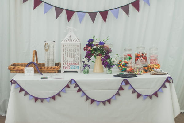 Wedding sweet table with purple bunting