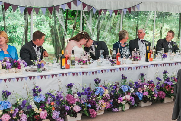 Wedding top table with flowers in front