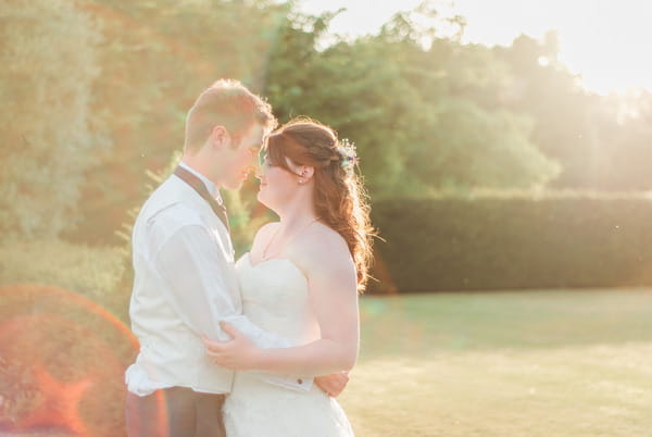 Bride and groom in hazy sunshine at Narborough Hall Gardens