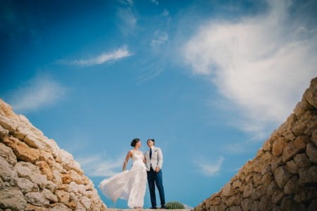 Bride and groom with beautiful blue sky behind them - Picture by Eclection Photography