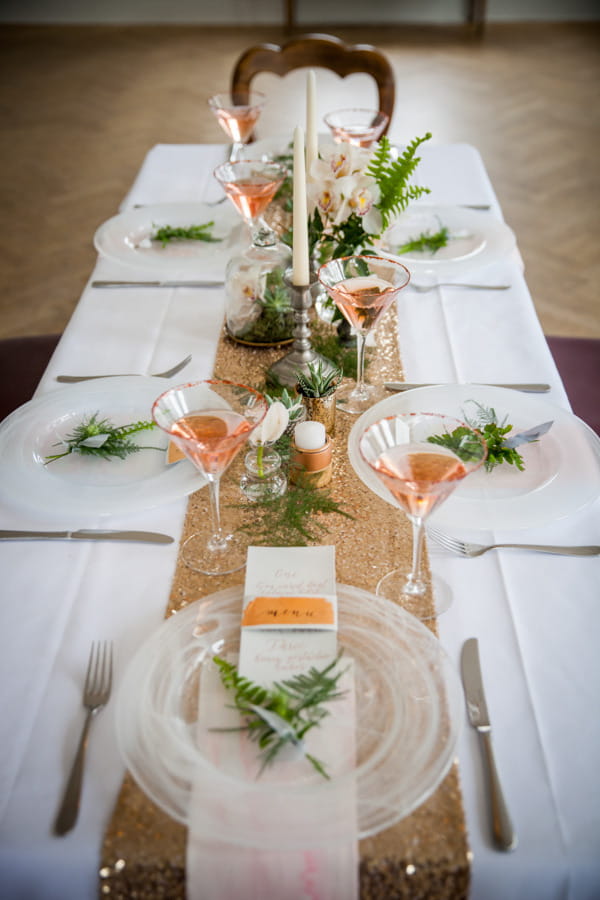 Wedding table dressed with copper details and foliage