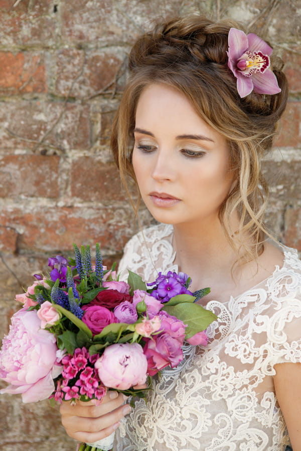 Bride with updo holding bouquet