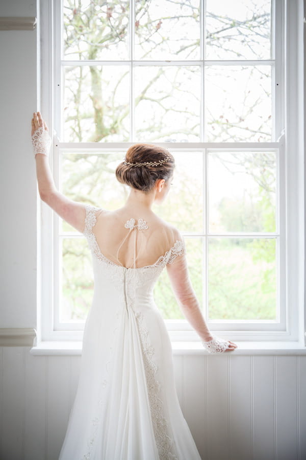 Bride standing by window at Belair House