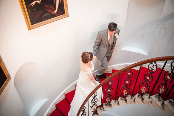 Bride and groom walking up stairs at Belair House