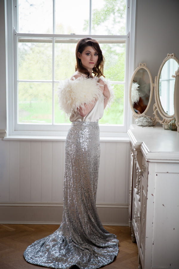 Bride in silver glittery skirt and fluffy shrug