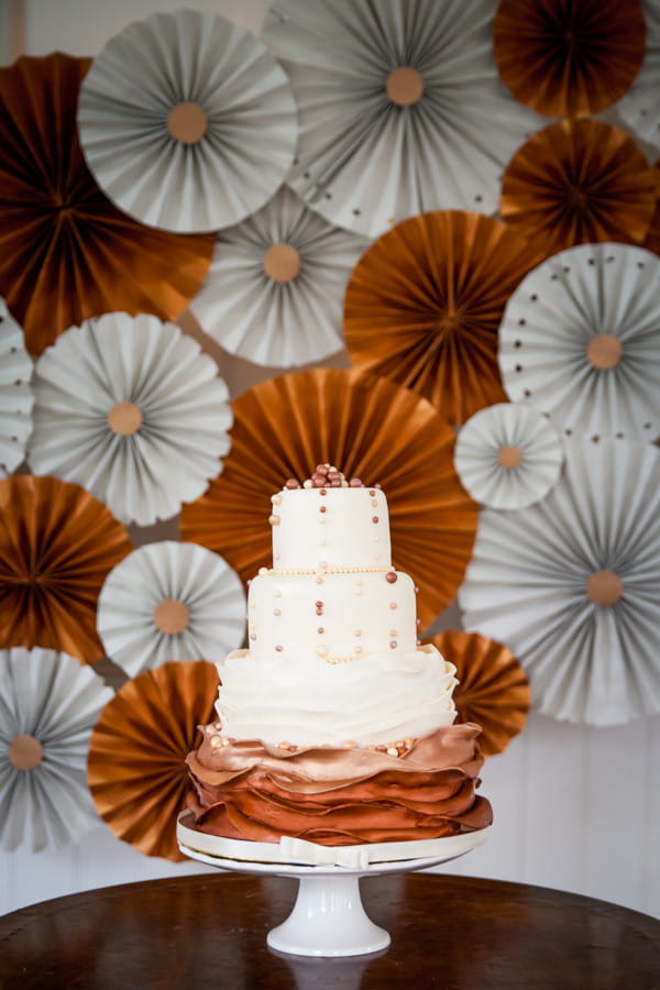 Wedding cake with copper and grey backdrop