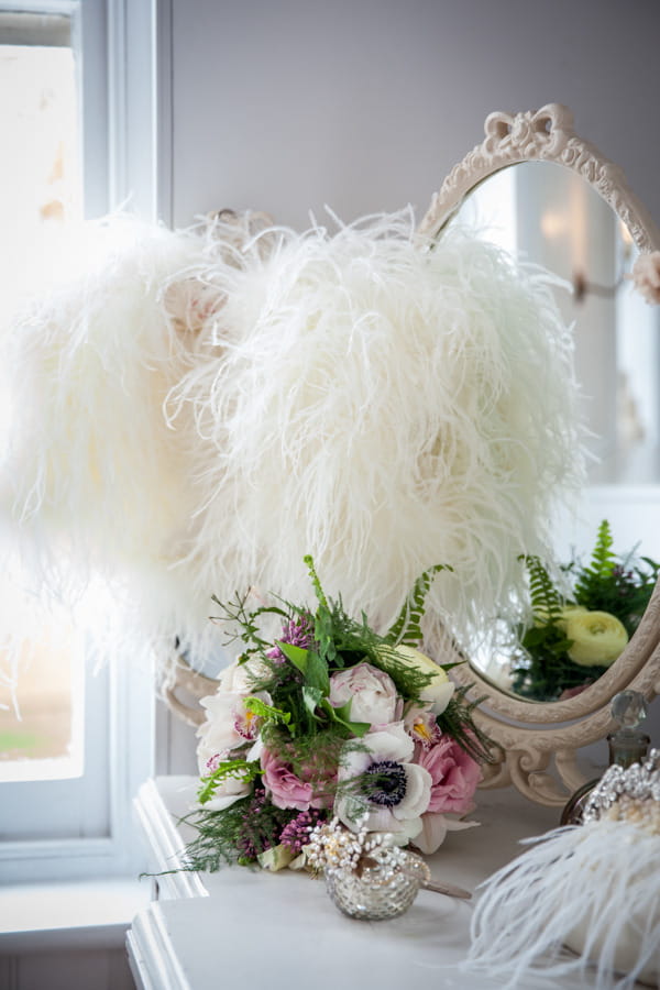 Shrug and wedding bouquet on dressing table