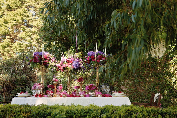 Long wedding table with large floral centrepiece