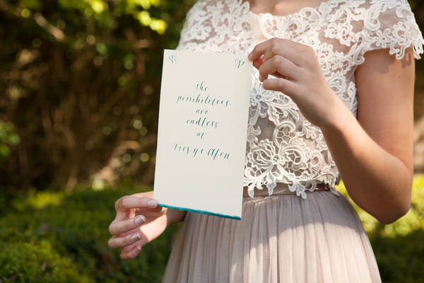 Bride holding wedding sign at Tros Yr Afon