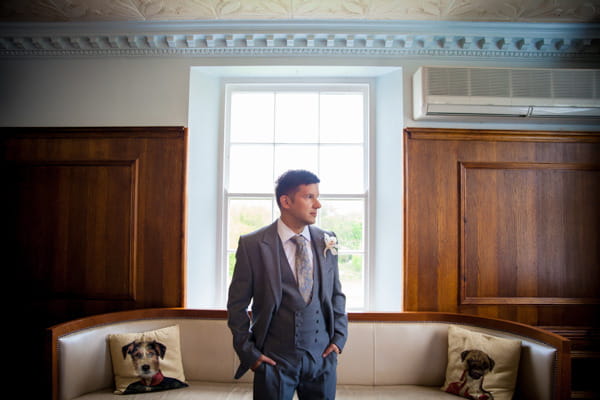 Groom with hands in pockets