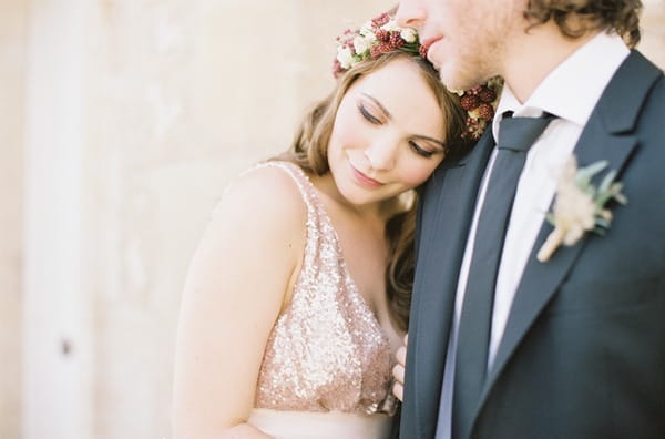 Bride resting head on groom's shoulder