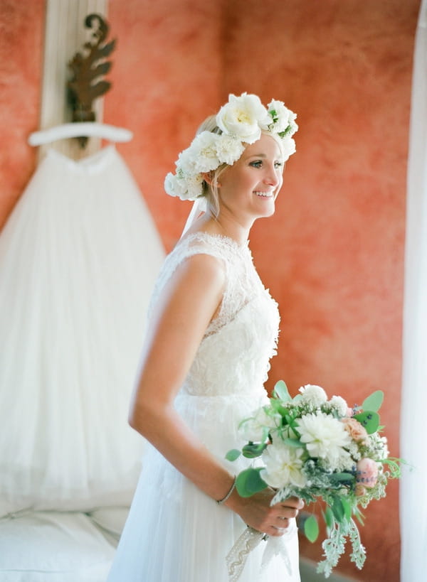 Bride with flower crown holding bouquet