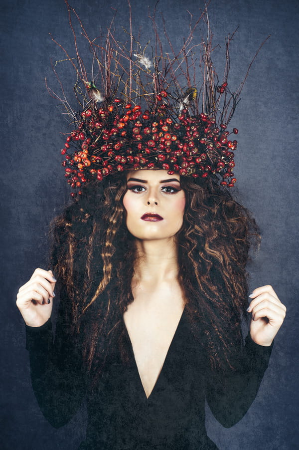 Bride wearing crown of sticks and red berries