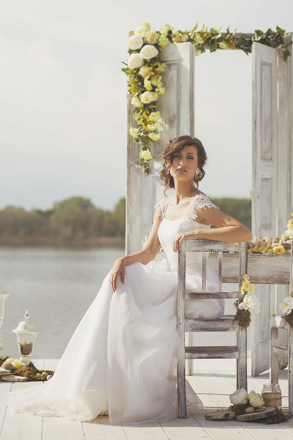Bride sitting by Lake of Candia in Italy